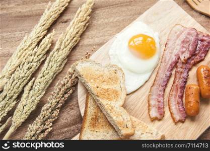 Freshly breakfast setting with black coffee and sauaage bacon omelette on the table wooden overhead shot with copyspace