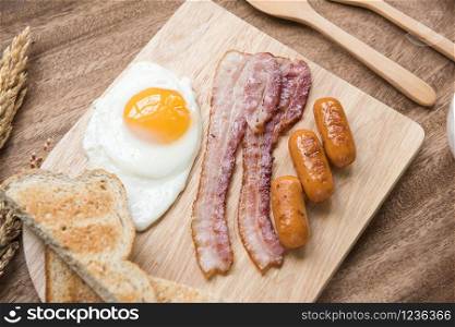 Freshly breakfast setting with sauaage bacon omelette on the table wooden overhead shot with copyspace