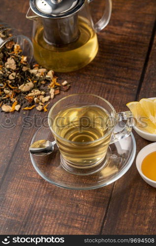 Freshly brewed hot winter tea on a wooden table