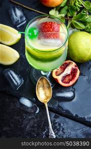 freshly citrus juice. summer cocktail of fresh lime juice,orange on dark background