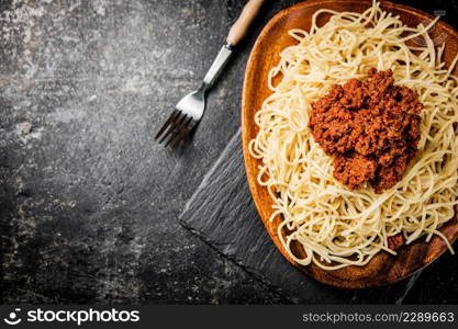 Freshly cooked spaghetti bolognese. On a black background. High quality photo. Freshly cooked spaghetti bolognese. On a black background.