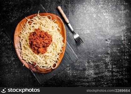 Freshly cooked spaghetti bolognese. On a black background. High quality photo. Freshly cooked spaghetti bolognese. On a black background.