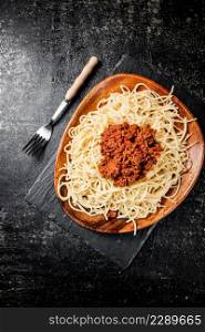 Freshly cooked spaghetti bolognese. On a black background. High quality photo. Freshly cooked spaghetti bolognese. On a black background.