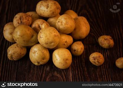 Freshly grown potato. Freshly grown potato on wooden table