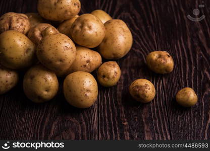 Freshly grown potato. Freshly grown potato on wooden table