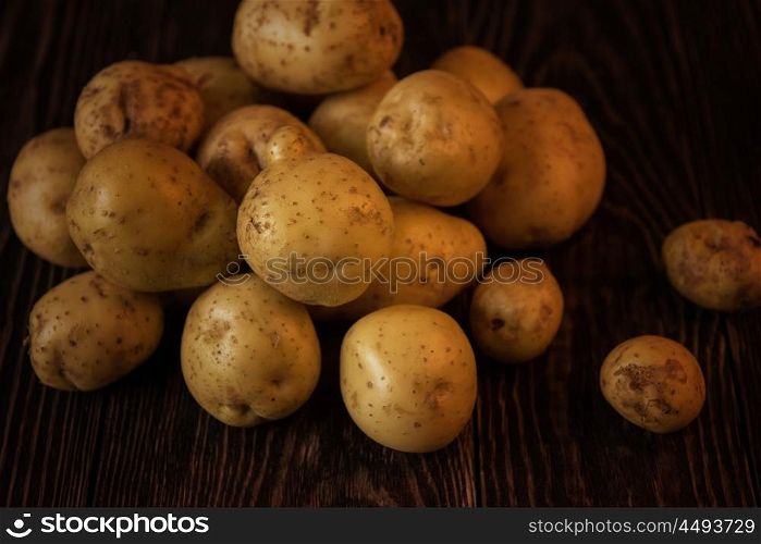 Freshly grown potato. Freshly grown potato on wooden table