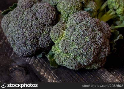 Freshly harvested organic Barese broccoli, on black wooden background