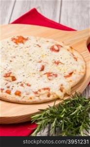 Freshly homemade pizza on wooden background