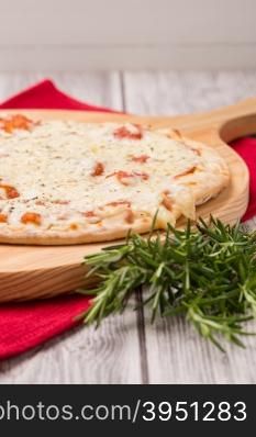 Freshly homemade pizza on wooden background