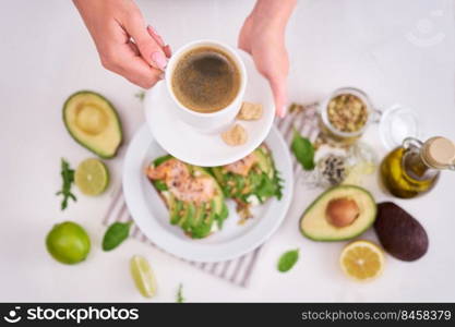 Freshly made Avocado, salmon and cream cheese toasts on a white ceramic plate.. Freshly made Avocado, salmon and cream cheese toasts on a white ceramic plate