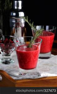 Freshly made cranberry smoothie with a sprig of rosemary