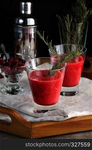 Freshly made cranberry smoothie with a sprig of rosemary