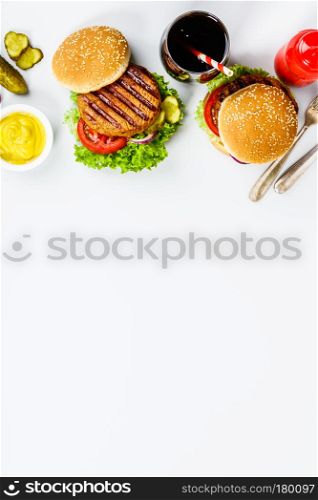 Freshly made hamburgers on light grey background, top view