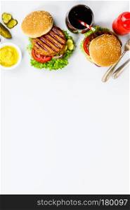 Freshly made hamburgers on light grey background, top view