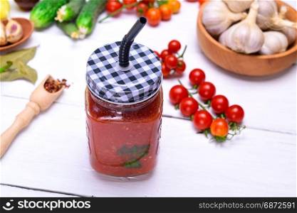 Freshly made juice from a ripe red tomato in a glass jar