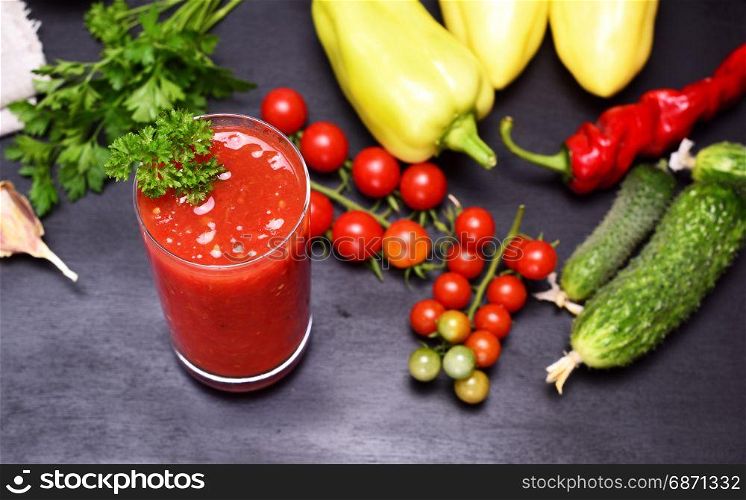 Freshly made juice of tomato and spices in a glass beaker, top view, selective focus