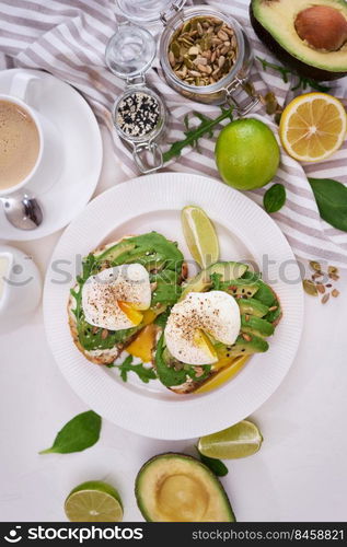 Freshly made poached egg and Avocado toasts on light grey background.. Freshly made poached egg and Avocado toasts on light grey background