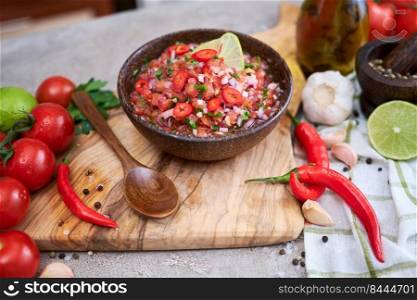 freshly made salsa dip sauce - chopped garlic, tomatoes and onion in wooden bowl.. freshly made salsa dip sauce - chopped garlic, tomatoes and onion in wooden bowl