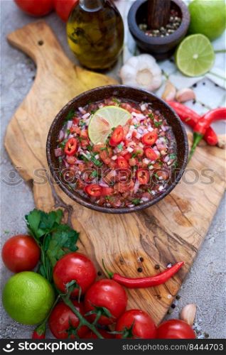 freshly made salsa dip sauce - chopped garlic, tomatoes and onion in wooden bowl.. freshly made salsa dip sauce - chopped garlic, tomatoes and onion in wooden bowl