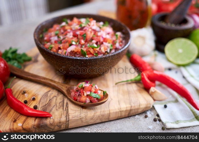 freshly made salsa dip sauce - chopped garlic, tomatoes and onion in wooden bowl.. freshly made salsa dip sauce - chopped garlic, tomatoes and onion in wooden bowl