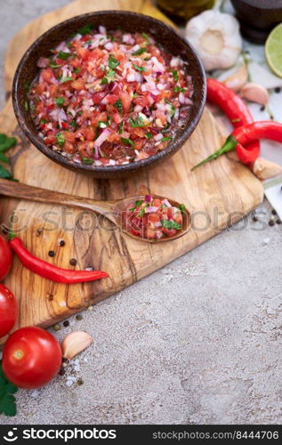 freshly made salsa dip sauce - chopped garlic, tomatoes and onion in wooden bowl.. freshly made salsa dip sauce - chopped garlic, tomatoes and onion in wooden bowl