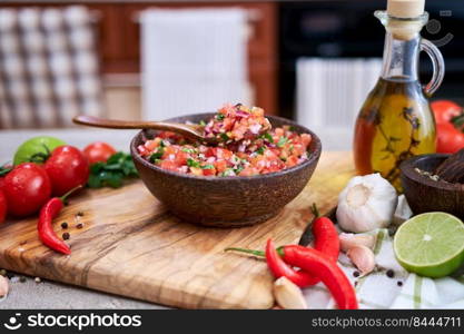 freshly made salsa dip sauce - chopped garlic, tomatoes and onion in wooden bowl.. freshly made salsa dip sauce - chopped garlic, tomatoes and onion in wooden bowl