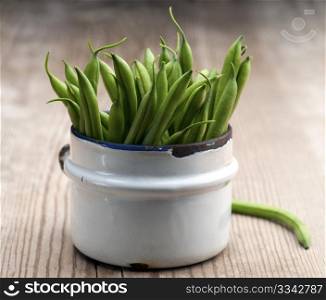 Freshly Picked Green Beans In An Old Enamel Mug On A Wooden Surface