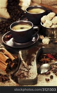 freshly prepared italian espresso with cinnamon, coffee beans, sugar and spices