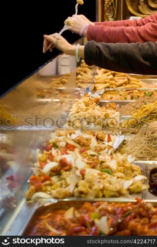 Freshly prepared oriental dishes on a market stall