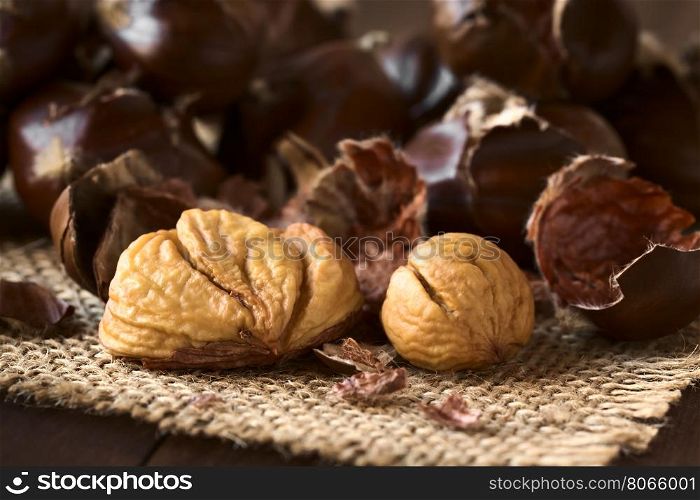 Freshly roasted or baked peeled chestnuts, photographed with natural light (Selective Focus, Focus on the front of the peeled chestnuts)