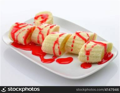 Freshly sliced bananas with strawberry topping