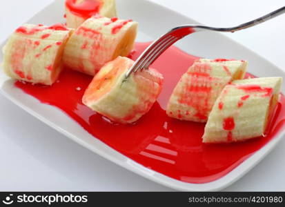 Freshly sliced bananas with strawberry topping