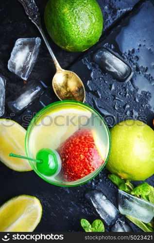 freshly squeezed citrus juice. summer cocktail of fresh lime juice,orange on dark blue background