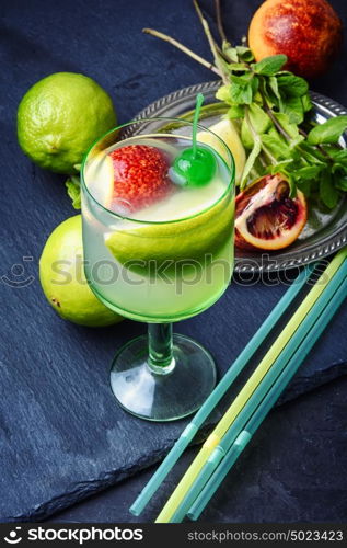 freshly squeezed citrus juice. tropical citrus fruit and refreshing drink on the slate stylish blue background