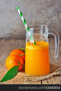 freshly squeezed tangerine juice on a wooden background