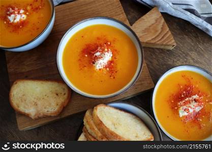 Freshness pumpkin creamy soup for autumn dinner on rustic table .. Freshness pumpkin creamy soup for autumn dinner on rustic table