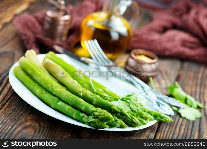 fried asparagus on plate and on a table