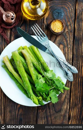 fried asparagus on plate and on a table