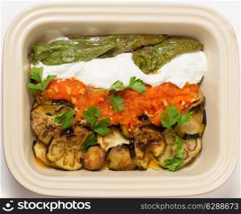 Fried aubergine (or eggplant) and fried mild green peppers served with garlic infused tomato and yogurt sauces. This is a traditional Turkish summer dish, served cold.