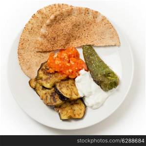 Fried aubergine (or eggplant) and fried mild green peppers served with garlic infused tomato and yogurt sauces. This is a traditional Turkish summer dish, served cold.