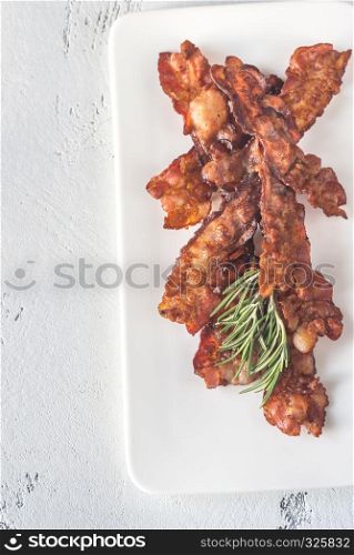 Fried bacon strips on the white plate