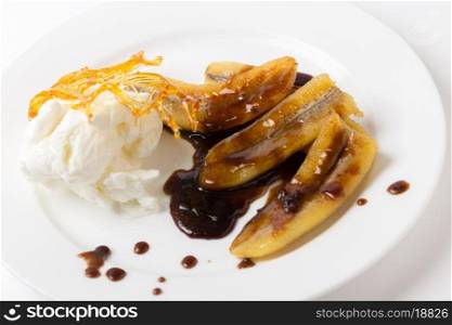 Fried bananas with a toffee sauce, ice cream and a caramelised sugar decoration.