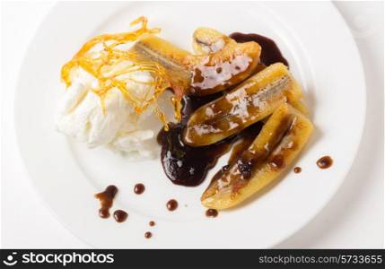 Fried bananas with a toffee sauce, ice cream and a caramelised sugar decoration.