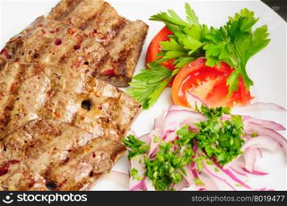 fried beef or pork liver with fresh vegetable salad served on plate. fried beef liver with vegetables