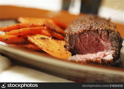Fried beef steak with carrots on the side