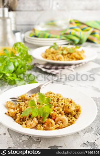 fried bulgur with shrimps on white plate