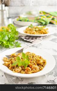 fried bulgur with shrimps on white plate