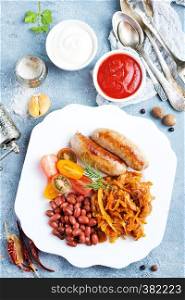 fried cabbage with fried sausages and tomato sauce