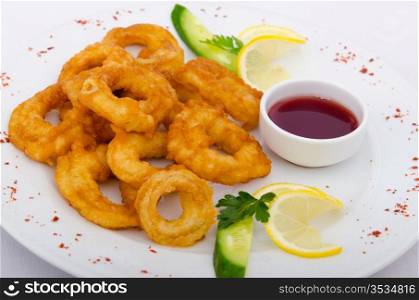 Fried calamari rings served with sauce
