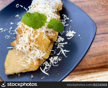 fried cassava with topping cheese on top, Indonesian traditional food, good for tea time or snack